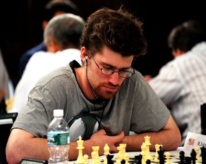 Mark Esserman concentrado ante el tablero, con unos auriculares en sus orejas